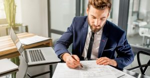 man looking at business structure documents, businessman working